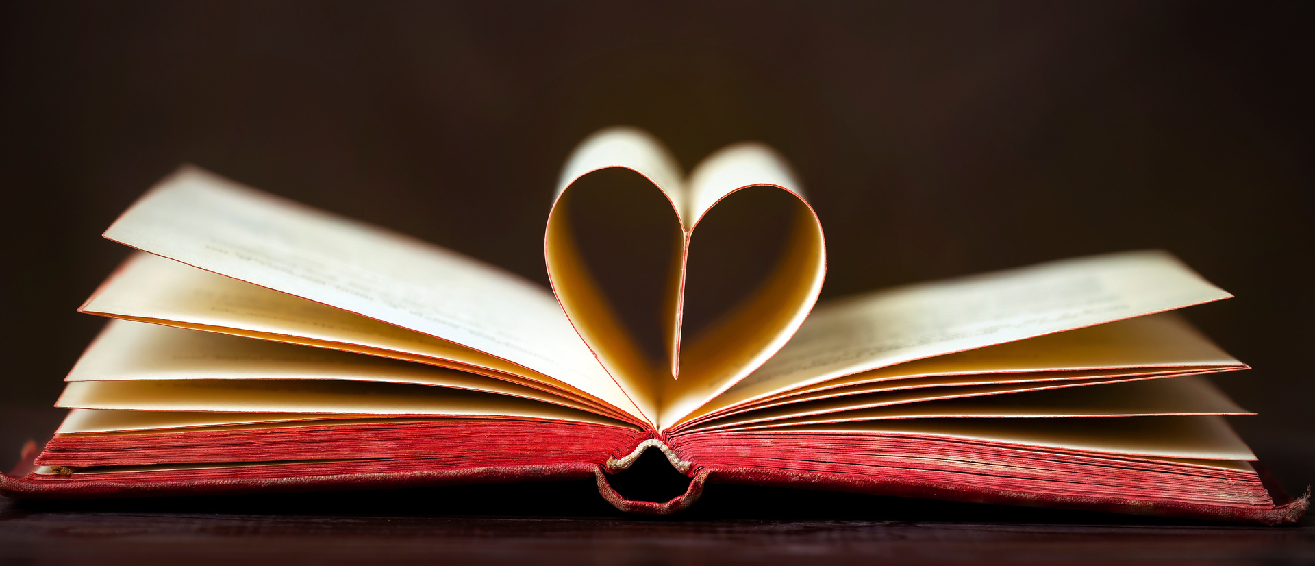 Old book with heart shape, love story, self love concept